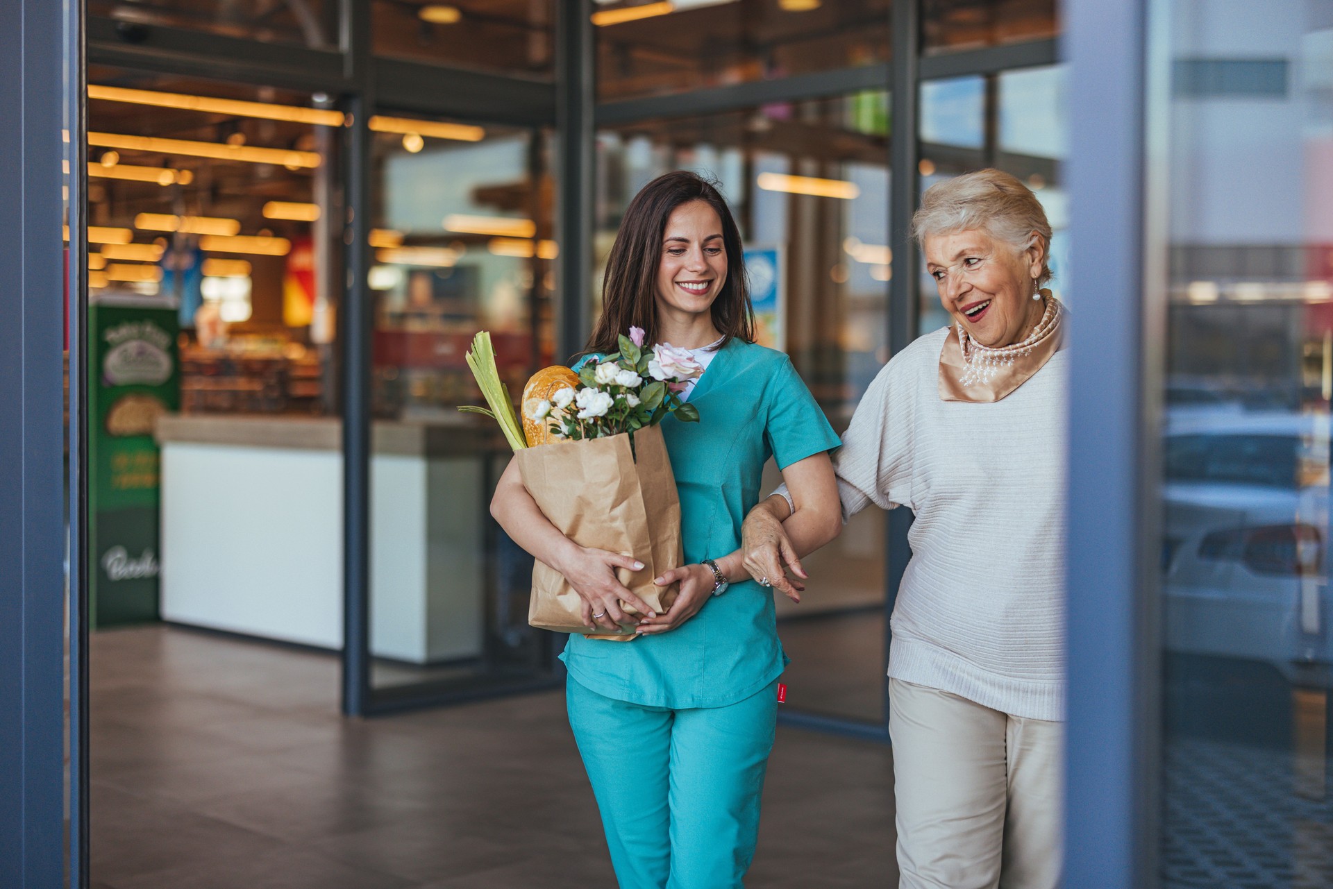 Young Caregiver Assisting Elderly Woman with Grocery Shopping
